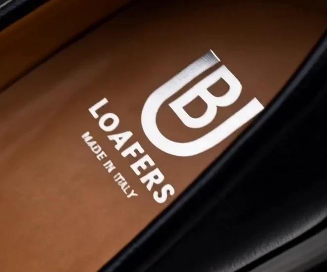 The tan leather insole printed with the BU Loafers logo